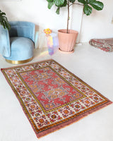 Small Turkish rug in a living room setting, pile rug, Turkish rug, vintage rug, portland, rug shop, bright colors, wild shaman, area rug, red rug, mini rug, bold color, Portland, Oregon, rug store, rug shop, local shop, flat weave, kilim rug