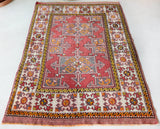 Small Turkish rug in a living room setting, pile rug, Turkish rug, vintage rug, portland, rug shop, bright colors, wild shaman, area rug, red rug, mini rug, bold color, Portland, Oregon, rug store, rug shop, local shop, flat weave, kilim rug