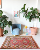 Small Turkish rug in a living room setting, pile rug, Turkish rug, vintage rug, portland, rug shop, bright colors, wild shaman, area rug, red rug, mini rug, bold color, Portland, Oregon, rug store, rug shop, local shop, flat weave, kilim rug