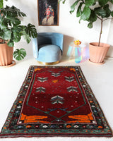 Small Turkish rug in a living room setting, pile rug, Turkish rug, vintage rug, portland, rug shop, bright colors, wild shaman, area rug, red rug, mini rug, bold color, Portland, Oregon, rug store, rug shop, local shop, flat weave, kilim rug