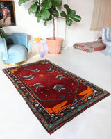 Small Turkish rug in a living room setting, pile rug, Turkish rug, vintage rug, portland, rug shop, bright colors, wild shaman, area rug, red rug, mini rug, bold color, Portland, Oregon, rug store, rug shop, local shop, flat weave, kilim rug