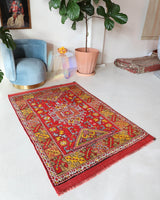 Small Turkish rug in a living room setting, pile rug, Turkish rug, vintage rug, portland, rug shop, bright colors, wild shaman, area rug, red rug, mini rug, bold color, Portland, Oregon, rug store, rug shop, local shop, flat weave, kilim rug