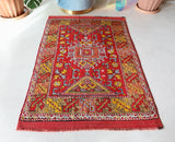 Small Turkish rug in a living room setting, pile rug, Turkish rug, vintage rug, portland, rug shop, bright colors, wild shaman, area rug, red rug, mini rug, bold color, Portland, Oregon, rug store, rug shop, local shop, flat weave, kilim rug