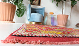 Small Turkish rug in a living room setting, pile rug, Turkish rug, vintage rug, portland, rug shop, bright colors, wild shaman, area rug, red rug, mini rug, bold color, Portland, Oregon, rug store, rug shop, local shop, flat weave, kilim rug