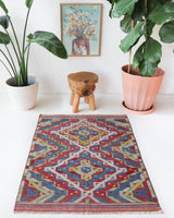 Vintage kilim rug in room decor setting, old rug, antique rug, pastel colors, faded colors, Turkish rug, vintage rug, soft rug, Portland, Oregon, rug store, rug shop, local shop,  antique kilim rug, bold colors, bright colors, faded colors