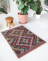 Vintage kilim rug in room decor setting, old rug, antique rug, pastel colors, faded colors, Turkish rug, vintage rug, soft rug, Portland, Oregon, rug store, rug shop, local shop,  antique kilim rug, bold colors, bright colors, faded colors