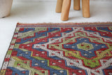 Vintage kilim rug in room decor setting, old rug, antique rug, pastel colors, faded colors, Turkish rug, vintage rug, soft rug, Portland, Oregon, rug store, rug shop, local shop,  antique kilim rug, bold colors, bright colors, faded colors