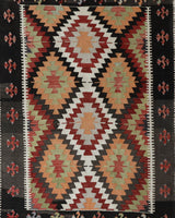 Vintage kilim rug in room decor setting, old rug, antique rug, pastel colors, faded colors, Turkish rug, vintage rug, soft rug, Portland, Oregon, rug store, rug shop, local shop, antique kilim rug, bold colors, bright colors, faded colors