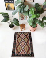 Vintage kilim rug in room decor setting, old rug, antique rug, pastel colors, faded colors, Turkish rug, vintage rug, soft rug, Portland, Oregon, rug store, rug shop, local shop, antique kilim rug, bold colors, bright colors, faded colors