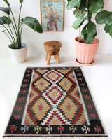 Vintage kilim rug in room decor setting, old rug, antique rug, pastel colors, faded colors, Turkish rug, vintage rug, soft rug, Portland, Oregon, rug store, rug shop, local shop, antique kilim rug, bold colors, bright colors, faded colors