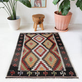 Vintage kilim rug in room decor setting, old rug, antique rug, pastel colors, faded colors, Turkish rug, vintage rug, soft rug, Portland, Oregon, rug store, rug shop, local shop, antique kilim rug, bold colors, bright colors, faded colors