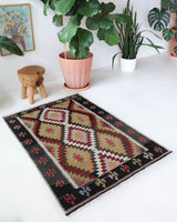 Vintage kilim rug in room decor setting, old rug, antique rug, pastel colors, faded colors, Turkish rug, vintage rug, soft rug, Portland, Oregon, rug store, rug shop, local shop, antique kilim rug, bold colors, bright colors, faded colors