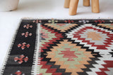 Vintage kilim rug in room decor setting, old rug, antique rug, pastel colors, faded colors, Turkish rug, vintage rug, soft rug, Portland, Oregon, rug store, rug shop, local shop, antique kilim rug, bold colors, bright colors, faded colors