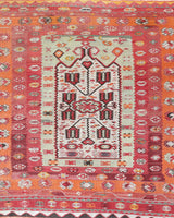 Vintage kilim rug in living room setting, old rug, antique rug, pastel colors, faded colors, Turkish rug, vintage rug, soft rug, Portland, Oregon, rug store, rug shop, local shop, earthy tones, earthy colors, warm colors