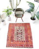 Vintage kilim rug in living room setting, old rug, antique rug, pastel colors, faded colors, Turkish rug, vintage rug, soft rug, Portland, Oregon, rug store, rug shop, local shop, earthy tones, earthy colors, warm colors