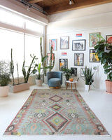 Vintage kilim rug in living room setting, old rug, antique rug, pastel colors, faded colors, Turkish rug, vintage rug, soft rug, Portland, Oregon, rug store, rug shop, local shop, earthy tones, earthy colors, warm colors