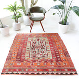 Vintage kilim rug in living room setting, old rug, antique rug, pastel colors, faded colors, Turkish rug, vintage rug, soft rug, Portland, Oregon, rug store, rug shop, local shop, earthy tones, earthy colors, warm colors