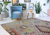 Vintage kilim rug in living room setting, old rug, antique rug, pastel colors, faded colors, Turkish rug, vintage rug, soft rug, Portland, Oregon, rug store, rug shop, local shop, earthy tones, earthy colors, warm colors