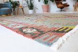 Vintage kilim rug in living room setting, old rug, antique rug, pastel colors, faded colors, Turkish rug, vintage rug, soft rug, Portland, Oregon, rug store, rug shop, local shop, earthy tones, earthy colors, warm colors