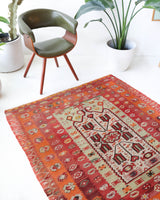 Vintage kilim rug in living room setting, old rug, antique rug, pastel colors, faded colors, Turkish rug, vintage rug, soft rug, Portland, Oregon, rug store, rug shop, local shop, earthy tones, earthy colors, warm colors