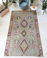 Vintage kilim rug in living room setting, old rug, antique rug, pastel colors, faded colors, Turkish rug, vintage rug, soft rug, Portland, Oregon, rug store, rug shop, local shop, earthy tones, earthy colors, warm colors