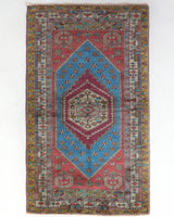 Vintage Turkish rug in living room setting, old rug, antique rug, pastel colors, faded colors, Turkish rug, vintage rug, soft rug, Portland, Oregon, rug store, rug shop, local shop