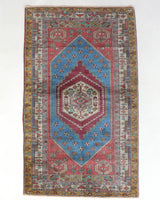 Vintage Turkish rug in living room setting, old rug, antique rug, pastel colors, faded colors, Turkish rug, vintage rug, soft rug, Portland, Oregon, rug store, rug shop, local shop