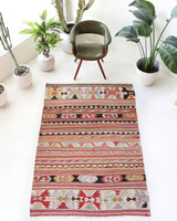 Vintage kilim rug in living room setting, old rug, antique rug, pastel colors, faded colors, Turkish rug, vintage rug, soft rug, Portland, Oregon, rug store, rug shop, local shop, earthy tones, earthy colors, warm colors
