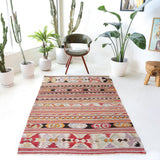 Vintage kilim rug in living room setting, old rug, antique rug, pastel colors, faded colors, Turkish rug, vintage rug, soft rug, Portland, Oregon, rug store, rug shop, local shop, earthy tones, earthy colors, warm colors
