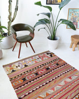 Vintage kilim rug in living room setting, old rug, antique rug, pastel colors, faded colors, Turkish rug, vintage rug, soft rug, Portland, Oregon, rug store, rug shop, local shop, earthy tones, earthy colors, warm colors