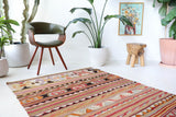 Vintage kilim rug in living room setting, old rug, antique rug, pastel colors, faded colors, Turkish rug, vintage rug, soft rug, Portland, Oregon, rug store, rug shop, local shop, earthy tones, earthy colors, warm colors