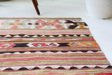 Vintage kilim rug in living room setting, old rug, antique rug, pastel colors, faded colors, Turkish rug, vintage rug, soft rug, Portland, Oregon, rug store, rug shop, local shop, earthy tones, earthy colors, warm colors