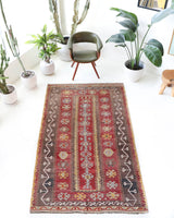 Vintage kilim rug in living room setting, old rug, antique rug, pastel colors, faded colors, Turkish rug, vintage rug, soft rug, Portland, Oregon, rug store, rug shop, local shop, earthy tones, earthy colors, warm colors