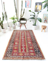 Vintage kilim rug in living room setting, old rug, antique rug, pastel colors, faded colors, Turkish rug, vintage rug, soft rug, Portland, Oregon, rug store, rug shop, local shop, earthy tones, earthy colors, warm colors