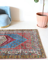 Vintage Turkish rug in living room setting, old rug, antique rug, pastel colors, faded colors, Turkish rug, vintage rug, soft rug, Portland, Oregon, rug store, rug shop, local shop