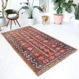 Vintage kilim rug in living room setting, old rug, antique rug, pastel colors, faded colors, Turkish rug, vintage rug, soft rug, Portland, Oregon, rug store, rug shop, local shop, earthy tones, earthy colors, warm colors