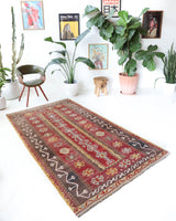 Vintage kilim rug in living room setting, old rug, antique rug, pastel colors, faded colors, Turkish rug, vintage rug, soft rug, Portland, Oregon, rug store, rug shop, local shop, earthy tones, earthy colors, warm colors
