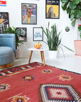 Vintage kilim rug in living room setting, old rug, antique rug, pastel colors, faded colors, Turkish rug, vintage rug, soft rug, Portland, Oregon, rug store, rug shop, local shop, earthy tones, earthy colors, warm colors