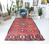 Vintage kilim rug in living room setting, old rug, antique rug, pastel colors, faded colors, Turkish rug, vintage rug, soft rug, Portland, Oregon, rug store, rug shop, local shop, earthy tones, earthy colors, warm colors