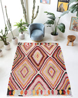 Vintage kilim rug in room decor setting, old rug, antique rug, pastel colors, faded colors, Turkish rug, vintage rug, soft rug, Portland, Oregon, rug store, rug shop, local shop, antique kilim rug, bold colors, bright colors, faded colors