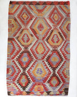 Vintage kilim rug in room decor setting, old rug, antique rug, pastel colors, faded colors, Turkish rug, vintage rug, soft rug, Portland, Oregon, rug store, rug shop, local shop, antique kilim rug, bold colors, bright colors, faded colors
