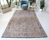 Vintage kilim rug in living room setting, old rug, antique rug, pastel colors, faded colors, Turkish rug, vintage rug, soft rug, Portland, Oregon, rug store, rug shop, local shop, earthy tones, earthy colors, warm colors