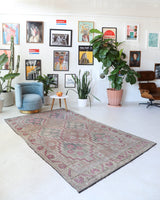 Vintage kilim rug in living room setting, old rug, antique rug, pastel colors, faded colors, Turkish rug, vintage rug, soft rug, Portland, Oregon, rug store, rug shop, local shop, earthy tones, earthy colors, warm colors
