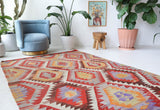 Vintage kilim rug in room decor setting, old rug, antique rug, pastel colors, faded colors, Turkish rug, vintage rug, soft rug, Portland, Oregon, rug store, rug shop, local shop, antique kilim rug, bold colors, bright colors, faded colors