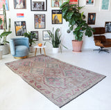 Vintage kilim rug in living room setting, old rug, antique rug, pastel colors, faded colors, Turkish rug, vintage rug, soft rug, Portland, Oregon, rug store, rug shop, local shop, earthy tones, earthy colors, warm colors