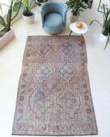 Vintage kilim rug in living room setting, old rug, antique rug, pastel colors, faded colors, Turkish rug, vintage rug, soft rug, Portland, Oregon, rug store, rug shop, local shop, earthy tones, earthy colors, warm colors