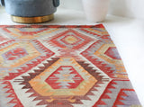 Vintage kilim rug in room decor setting, old rug, antique rug, pastel colors, faded colors, Turkish rug, vintage rug, soft rug, Portland, Oregon, rug store, rug shop, local shop, antique kilim rug, bold colors, bright colors, faded colors