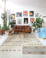 Vintage kilim rug in living room setting, old rug, antique rug, pastel colors, faded colors, Turkish rug, vintage rug, soft rug, Portland, Oregon, rug store, rug shop, local shop, earthy tones, earthy colors, warm colors