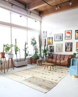 Vintage kilim rug in living room setting, old rug, antique rug, pastel colors, faded colors, Turkish rug, vintage rug, soft rug, Portland, Oregon, rug store, rug shop, local shop, earthy tones, earthy colors, warm colors