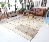 Vintage kilim rug in living room setting, old rug, antique rug, pastel colors, faded colors, Turkish rug, vintage rug, soft rug, Portland, Oregon, rug store, rug shop, local shop, earthy tones, earthy colors, warm colors